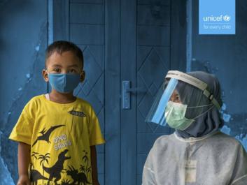 boy wearing mask with health worker